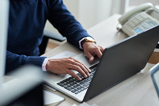 Person typing on a laptop at a desk